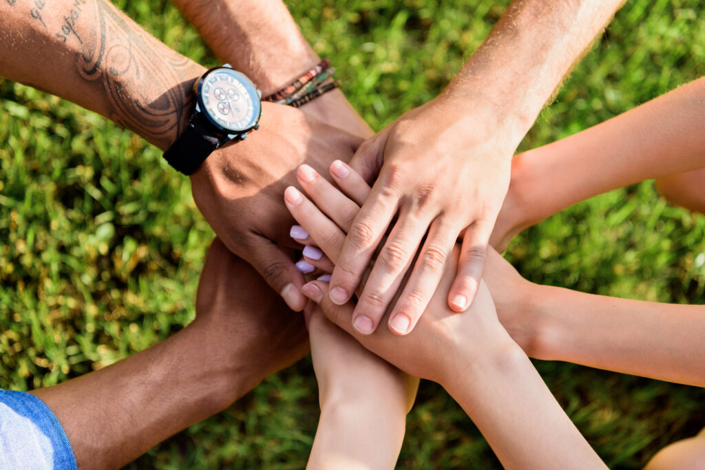 cropped shot of multiracial friends holding hands together