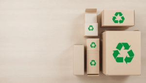The image depicts several packaging boxes prominently featuring the recycle logo, symbolizing a commitment to sustainable packaging practices. These eco-friendly boxes represent a shift towards using recycled materials and reducing packaging waste in various industries, aligning with the growing consumer demand for sustainable solutions.