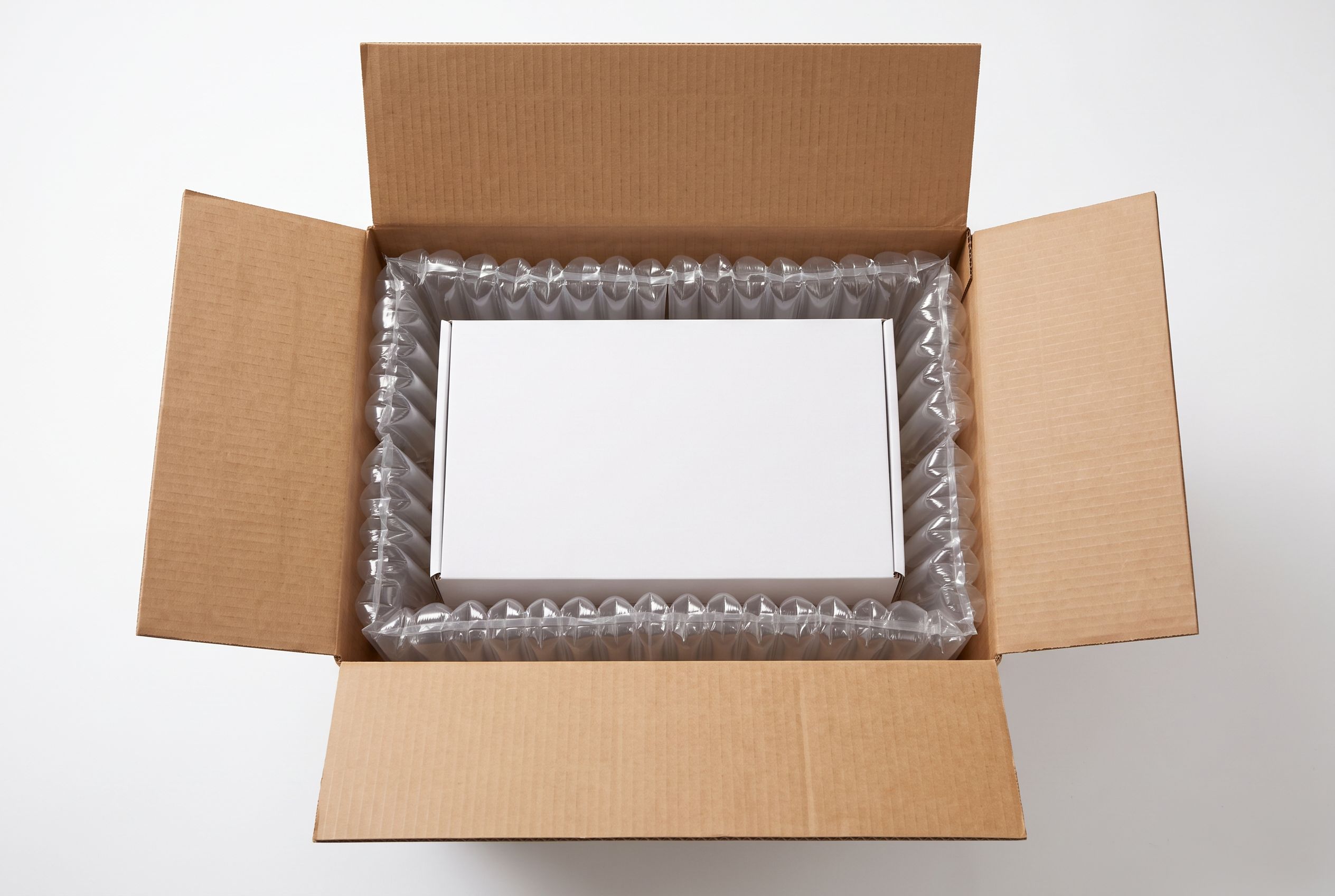 A right-sized shipping box using air pillow void fill instead of oversized packaging
